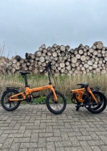 Revolt Carbon Fiber Pro V2 E-Bike, Belt Drive, Chain Drive, Rear Suspension, Pale Orange, Folded